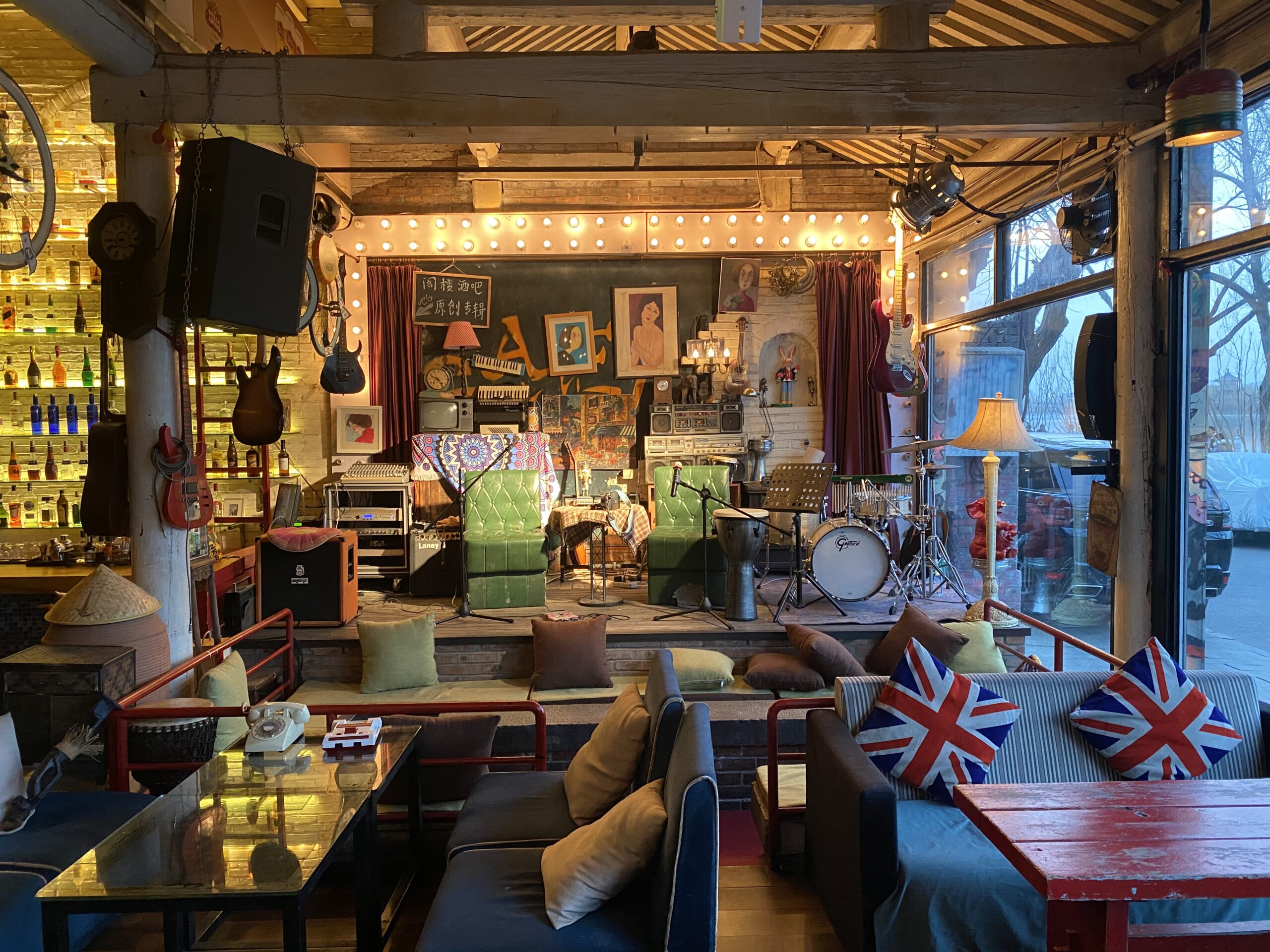Eclectic music lounge with drum kit, guitars and Union Jack pillows