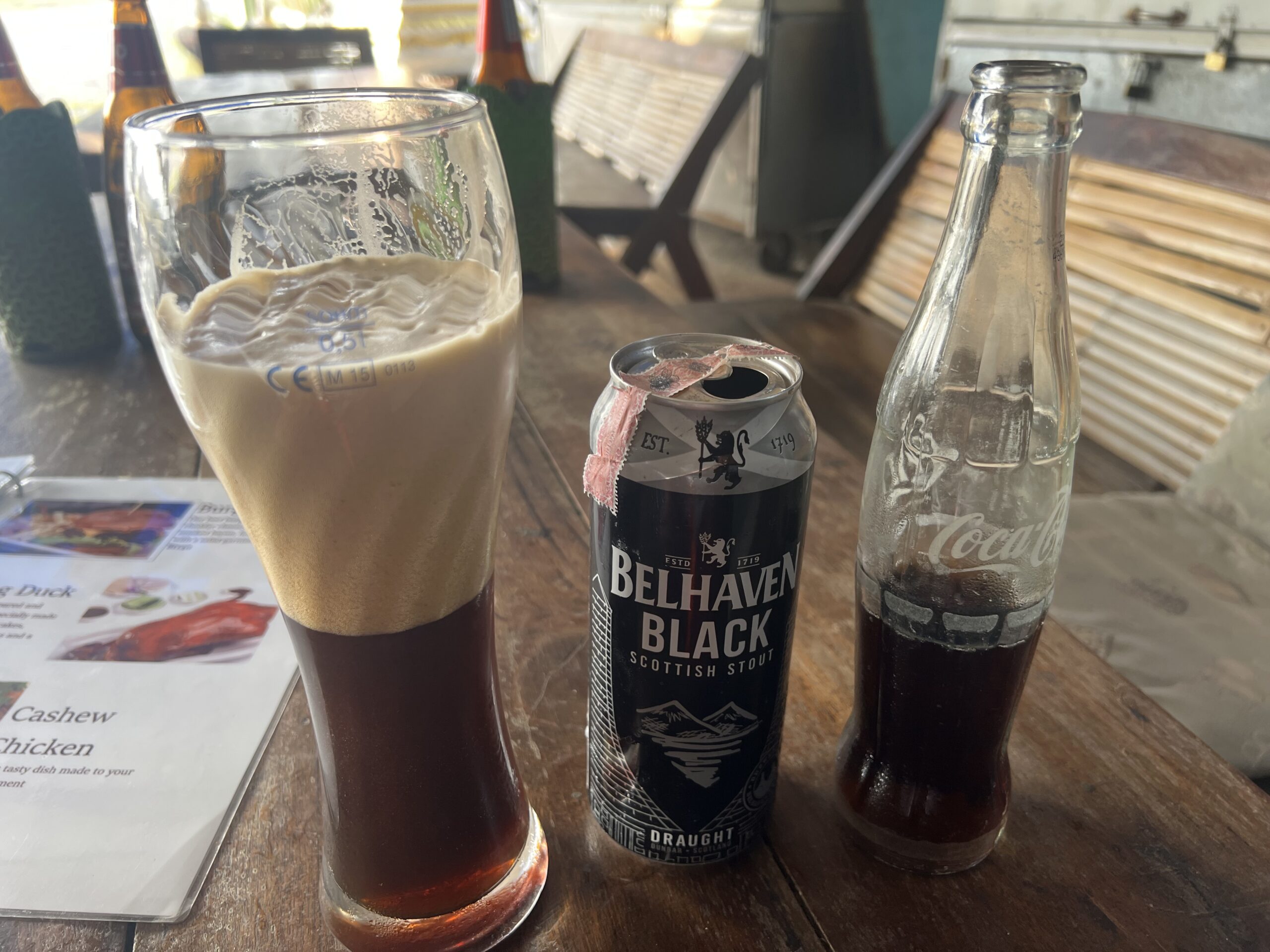 Belhaven Black beer can and Coke at a restaurant in Ubon