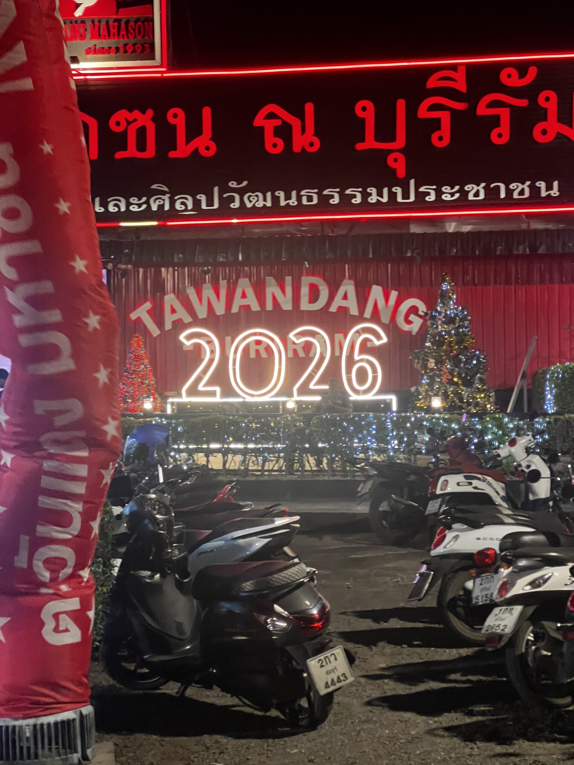 Neon Tawandang Brewery sign glowing at night in Buriram