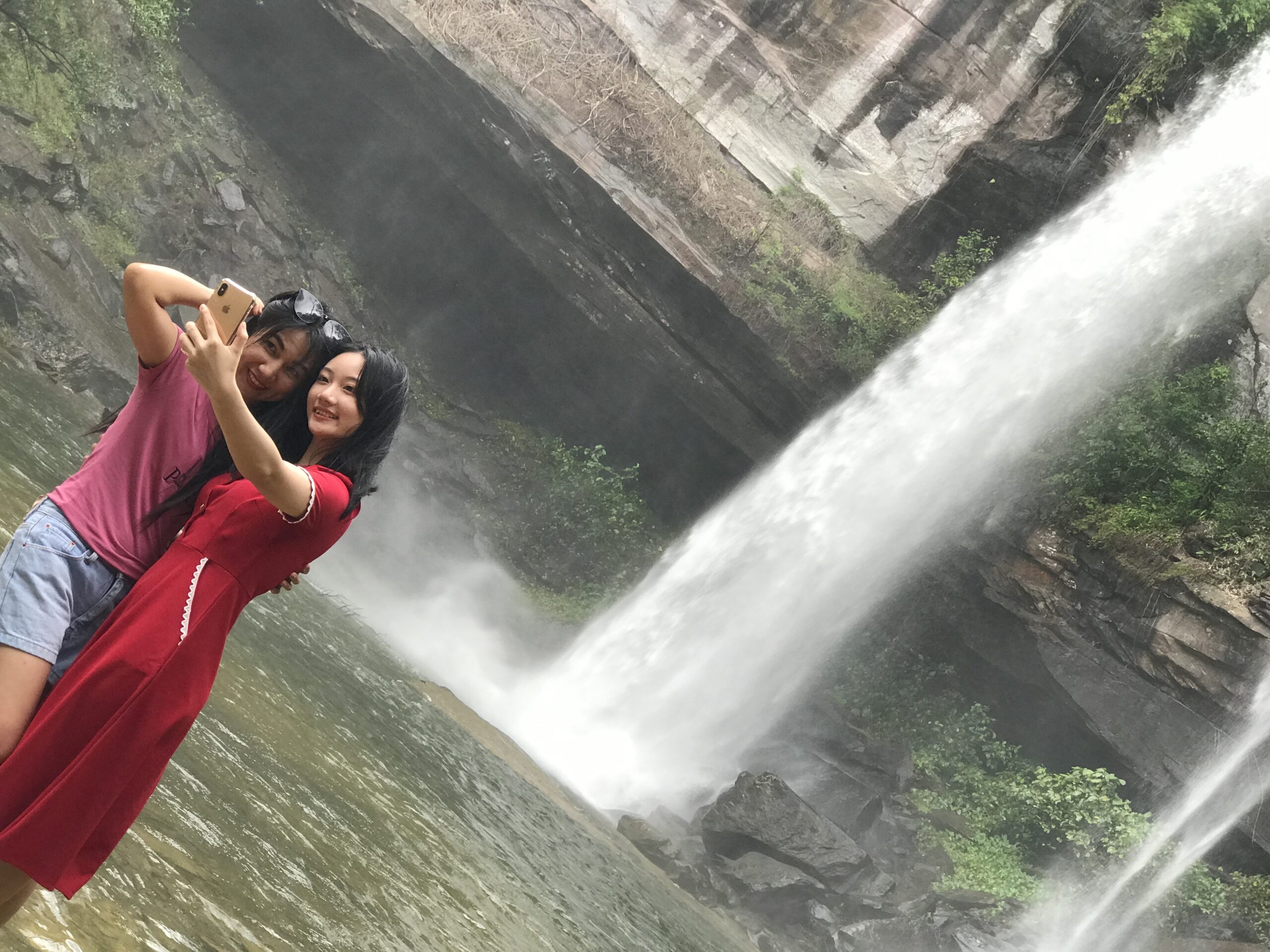 Two women by the waterfall at Phu Chong Na Yoi National Park