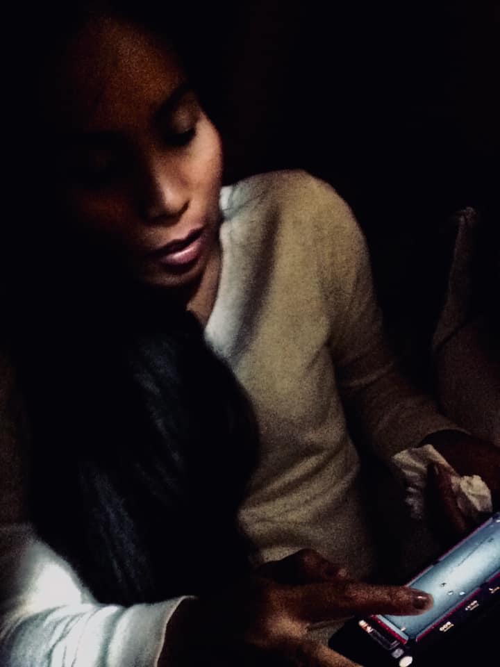 Young woman quietly contemplating her phone on the night train to Isan