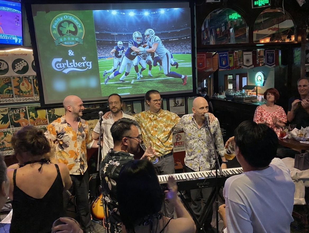 Men enjoying a lively evening at Paddy O’Shea’s bar